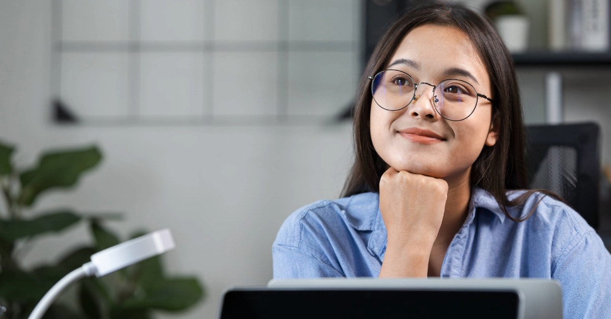 Mulher com expressão pensativa em frente ao computador pensando em como cancelar o mei