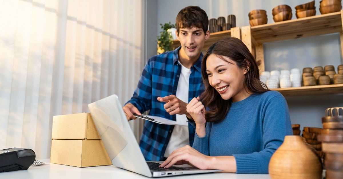 Homem e mulher em frente ao notebook aprendendo sobre como vender mais